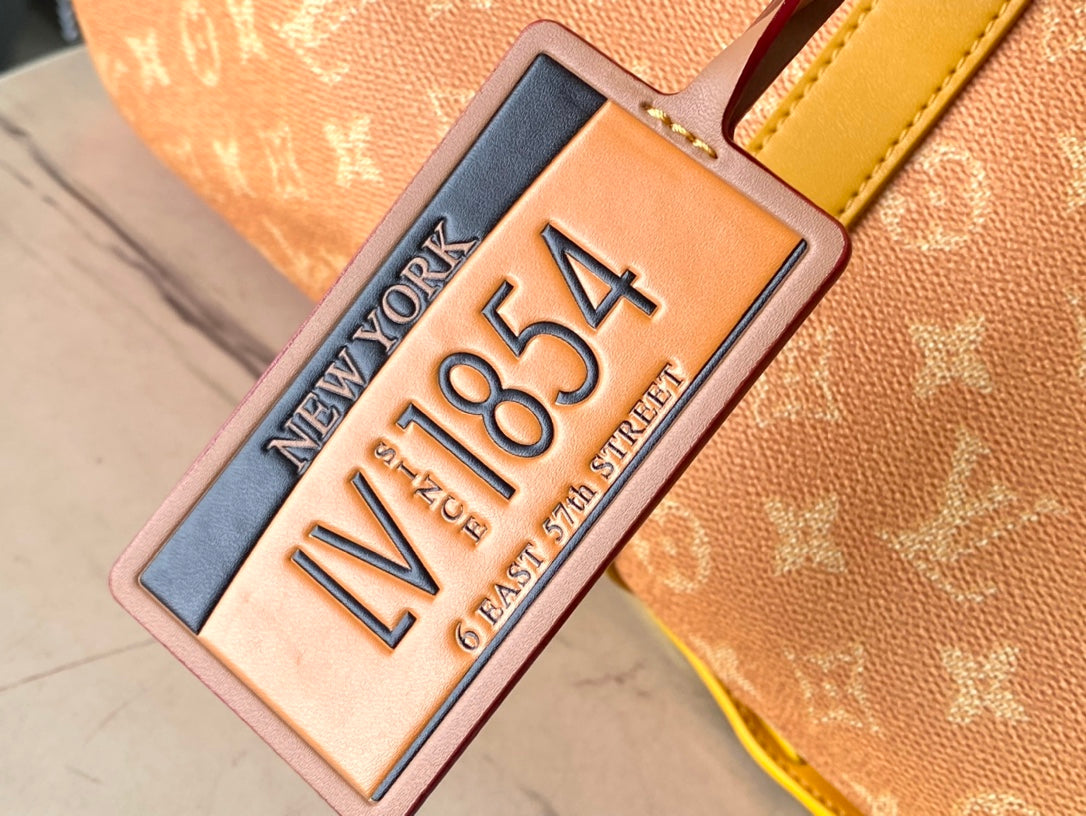 Louis Vuitton Keepall Bandoulière 55 in Orange Monogram Heritage Canvas Bag